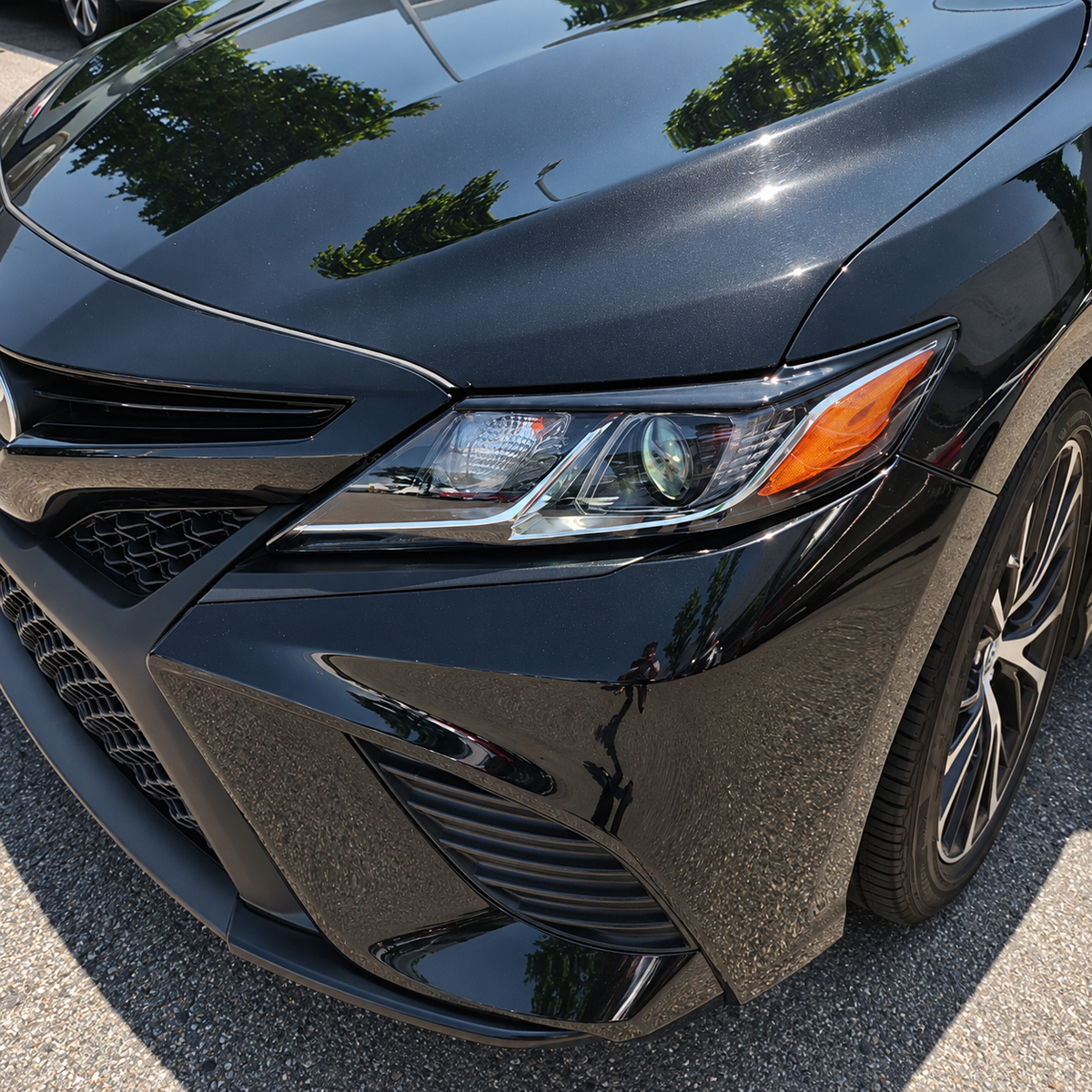 2018-2024 Camry Gloss Black Headlight Eyelid Covers — headlight eyelid above the lamp, vehicle close-up