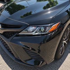 2018-2024 Camry Gloss Black Headlight Eyelid Covers — headlight eyelid above the lamp, vehicle close-up