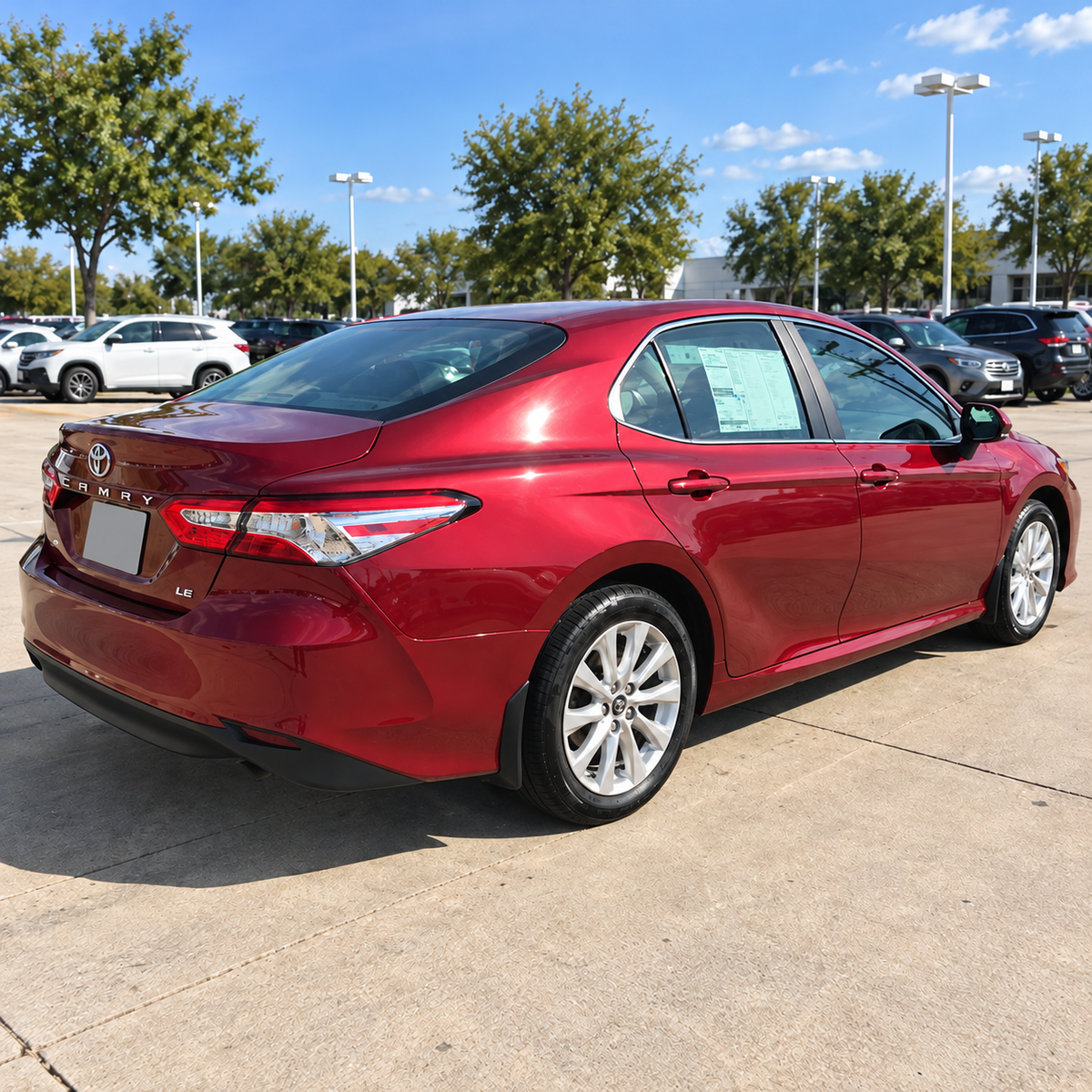 2018-2024 Camry LE/XLE 4-Piece Splash Guards — LE/XLE splash guards on a red Camry, rear angle