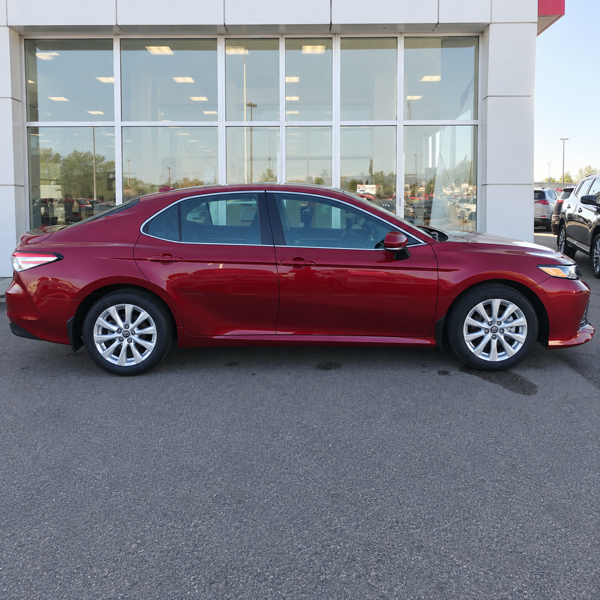 2018-2024 Camry LE/XLE 4-Piece Splash Guards — LE/XLE splash guards on a red Camry, full side view
